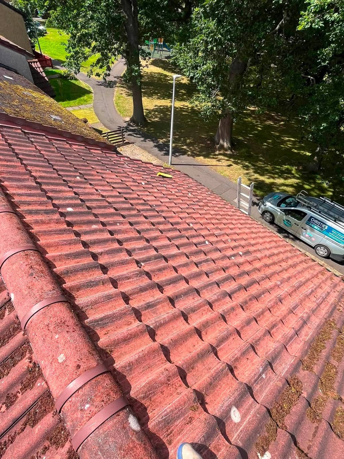 Red pantile roof seen along the ridge, with the Christie's Exterior Cleaning van parked below