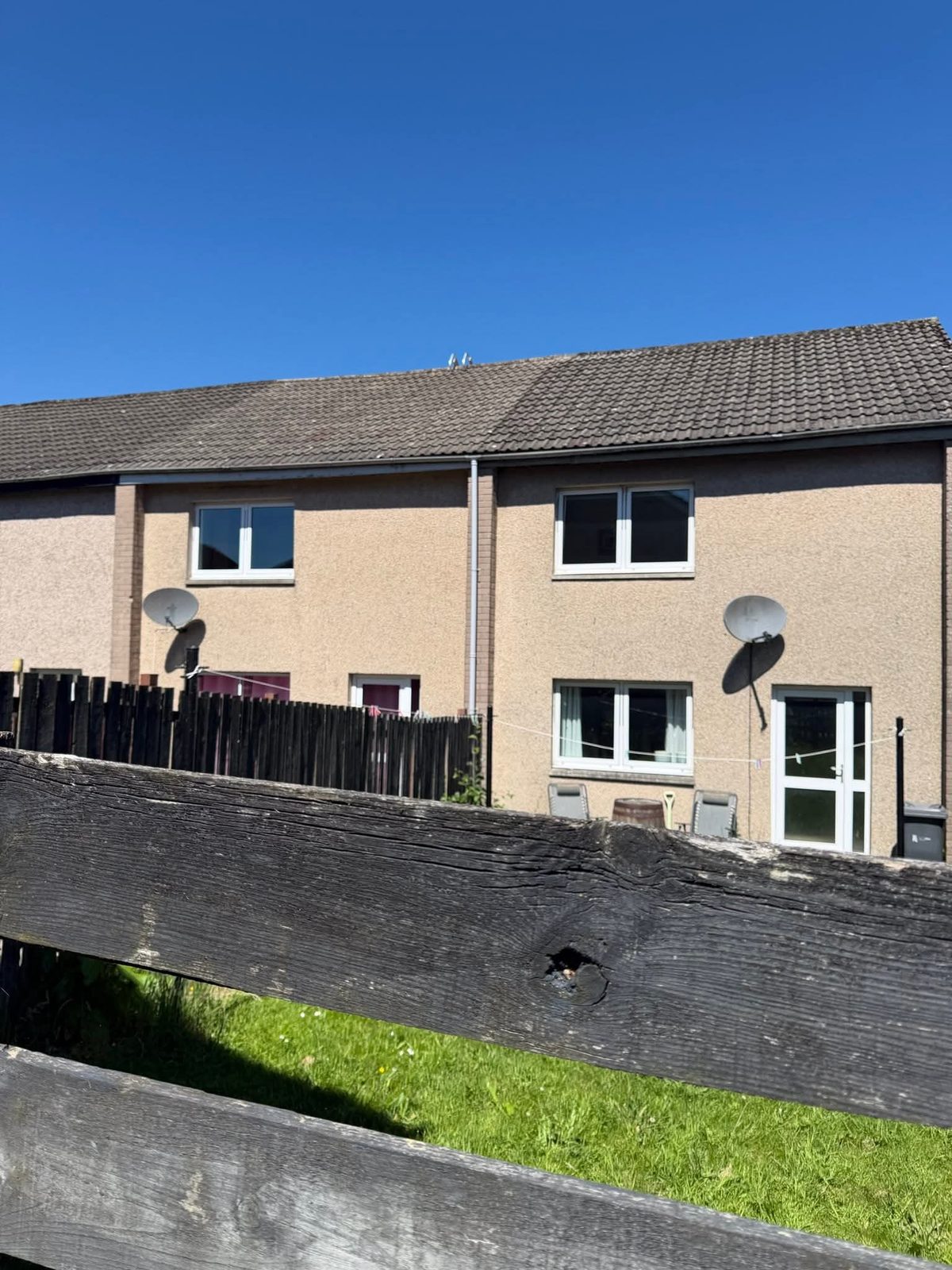 Rendered terraced houses with a clean concrete tiled roof